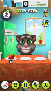 Screenshot of the game My Talking Tom showing a game screen where the character is in the kitchen and above the screen an ad for the Uber app, with the brand logo and the texts "Uber", "Free" and "Install".